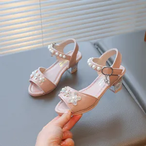 Detailed view of pink girls' princess sandals with pearls and rhinestone flowers