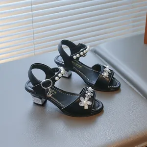 Detailed view of black girls princess sandals with pearl straps and rhinestone flowers