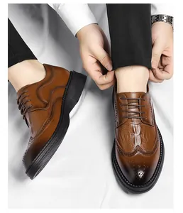 Close-up detail of brown men's crocodile embossed brogue dress shoes with thick soles.