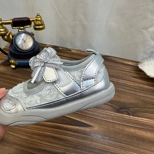 Detailed view of silver girls princess sandals featuring a pearl bow and breathable lace mesh
