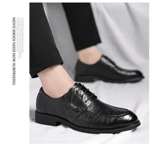 Detailed shot of men's black hollow-out leather dress shoes featuring retro hand-grabbed texture.