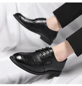 Close-up of black perforated leather dress shoes with textured hand-grabbed grain finish