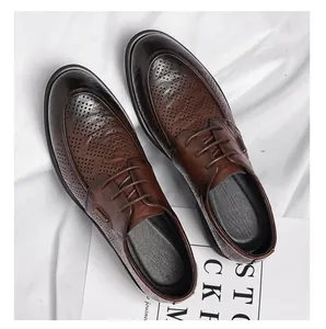 Detail of men's vintage brown leather shoes with perforated texture for business casual.
