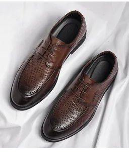Detail view of vintage brown men's business leather shoes with hollow brogue patterns.