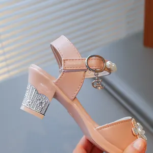 Detail view of pink princess sandal with rhinestone heel and crescent moon charm