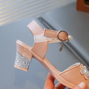 Detail of pink girls' princess sandal with sparkling rhinestone heel and pearl flower.