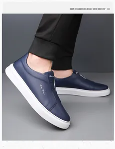 Navy blue men's slip-on leather shoes with soft white sole and textured finish
