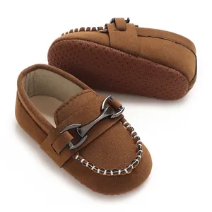 Detail shot of brown frosted leather baby moccasins with metal buckle and non-slip sole