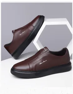 Detailed view of brown leather slip-on shoes with comfortable thick black soles.