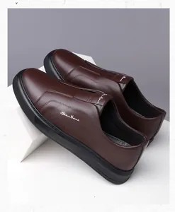 Detailed view of brown textured leather loafers with soft sole and slip-on design for men