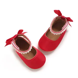 Detailansicht rote Satin-Babyschuhe mit Perlenverzierung und roten Fersenschleifen