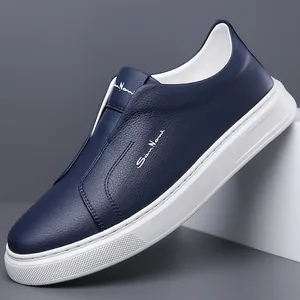 Classic navy blue leather slip-on sneakers for men with a soft white rubber sole.