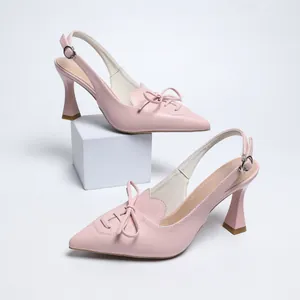 Elegant detail view of pink pointed toe slingback high heel sandals with stylish bow tie