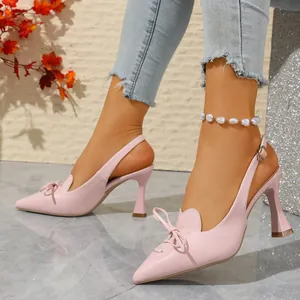 Elegant pink pointed-toe slingback high heels featuring a delicate bow and lace-up detail.