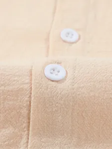 Close-up detail showing the texture of beige cotton linen men's shirt with white buttons