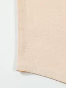 Macro view of breathable beige cotton linen fabric texture on casual men's beach shirt.