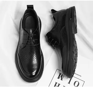 Detail view showing the intricate hollow laser-cut pattern on black men's leather shoes