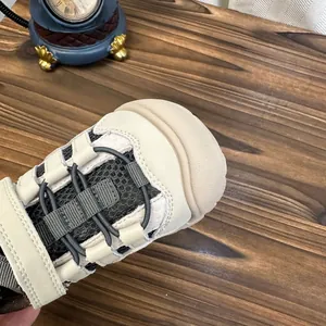 Gros plan détaillé de la maille respirante et du bout des baskets beiges pour enfants