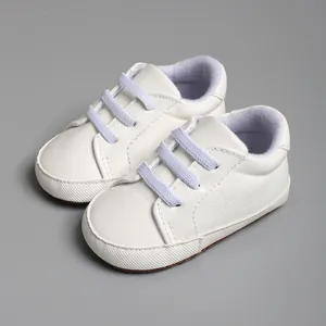 Vue détaillée de chaussures blanches à semelle souple pour bébé de 0 à 18 mois environ