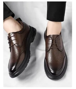 Close-up of breathable brown hollow business shoes for men with laser-cut details