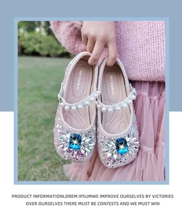Close-up view of pink glittery girls' princess shoes with blue gems and pearl straps