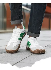 Outdoor close-up of men's barefoot sneakers featuring wide toe box and white mesh upper
