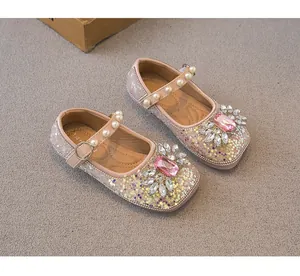 Detail view of pink glittery girls Mary Jane shoes with crystal flower and pearls