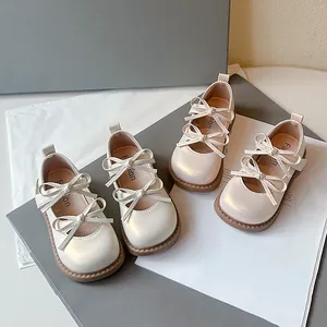 Elegantes zapatos Mary Jane blanco roto para niñas con diseño de doble lazo y suela blanda.