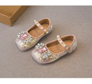 Detail view of sparkling pink girls' princess shoes with rhinestones and pearl straps.