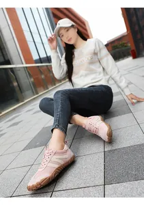 Action shot of pink minimalist barefoot walking shoes worn by a model on pavement.
