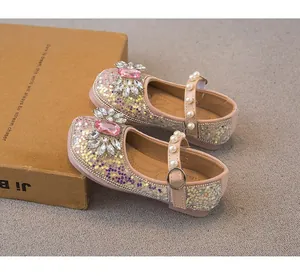 Detailed view of pink glitter girls princess shoes with rhinestone and pearl accents