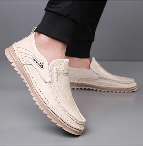 Side view of cream leather loafers for men with textured finish and serrated sole