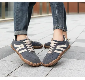 Detailed view of grey barefoot outdoor shoes with wide toe box and lugged rubber sole