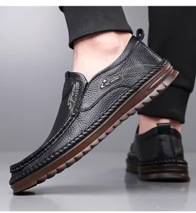 Detailed close-up of men's black pebbled leather loafer with Sport embroidery and brown sole