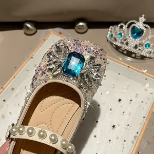 Sparkling girls' princess dress shoes with a large blue gemstone and pearl strap