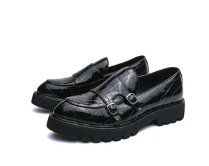 Detail van zwarte laklederen loafers met krokodillenpatroon en dubbele gespen