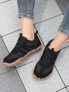 Lightweight black wide-toe barefoot sneakers for hiking and cycling on outdoor stone floor