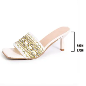 Elegant white Bohemian high-heel mules with 7cm heel and intricate gold embroidery detail