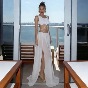 Close-up detail of sexy white mesh two-piece set featuring pearl chain and high slit skirt