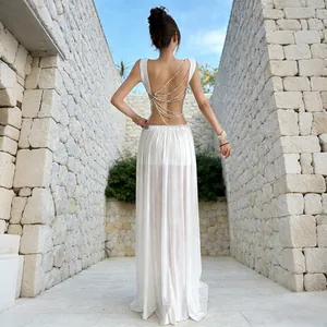 Back view of elegant white mesh skirt set with luxury pearl chain backless vest detail