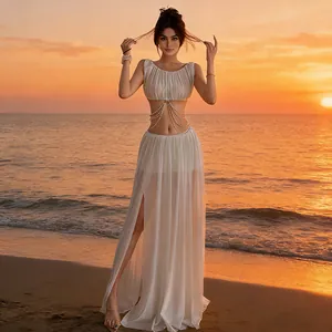Detailed view of white mesh skirt set with chain waist decor on sunset beach background