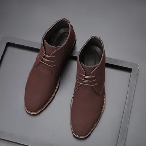 Detailed macro view showing the brown suede texture of men's pointed-toe lace boots