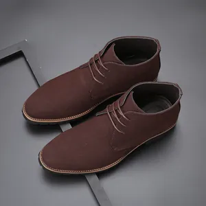 Detailed close-up of premium brown suede men's desert boots with classic lace-up design