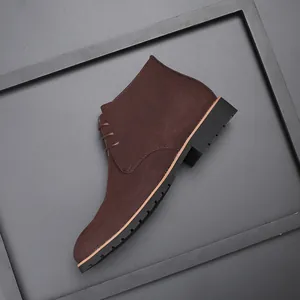 Detail of brown suede lace-up chukka boot with rugged rubber sole