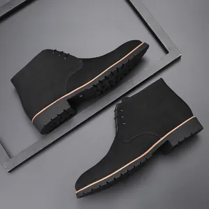 Close-up of black suede men's chukka boots with lace-up detail and thick rubber sole.