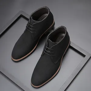 High-angle view of black suede men's chukka boots with pointed toes and lace-up design