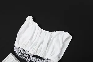 Detailed view of sexy white mesh ruched crop top with elegant faux pearl chain trim.