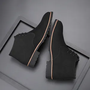 Professional top-down shot of men's black suede lace-up chukka boots with lug soles.