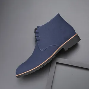 Detailed macro view of the navy blue suede texture on men's lace-up casual boots