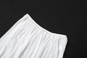 Detail view of white mesh see-through skirt waist with gathered elastic band texture